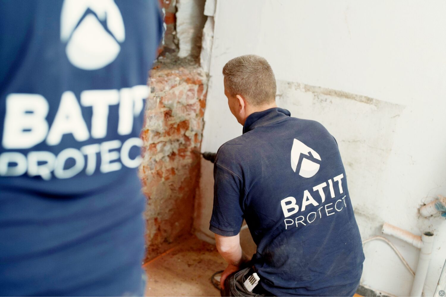 Techniciens Batit Protect réalisant un traitement humidité dans les murs